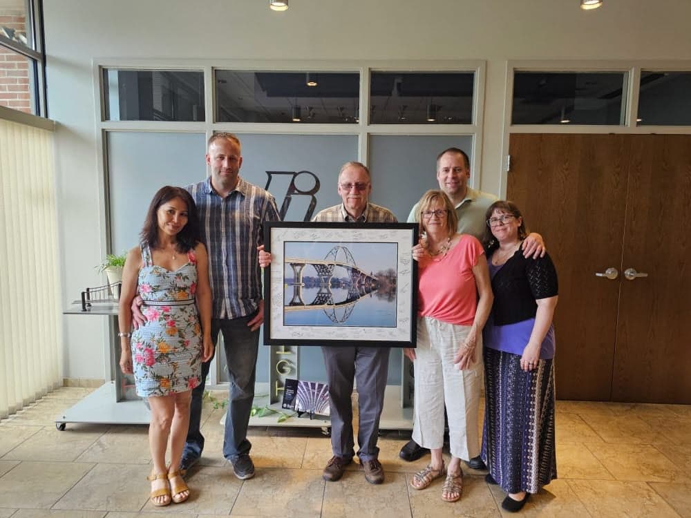 George and his family pose with his retirement gift