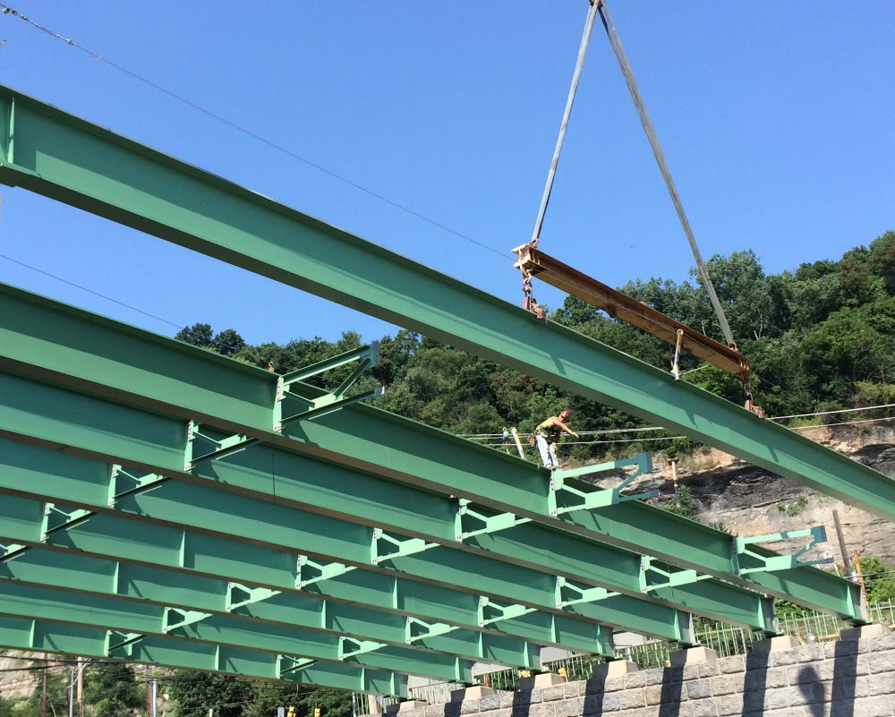 Painted Steel Girders are set into place at the jobsite.